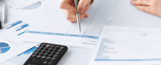 woman hand with calculator and papers