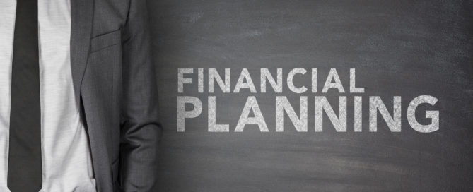 Financial planning text on black blackboard with businessman