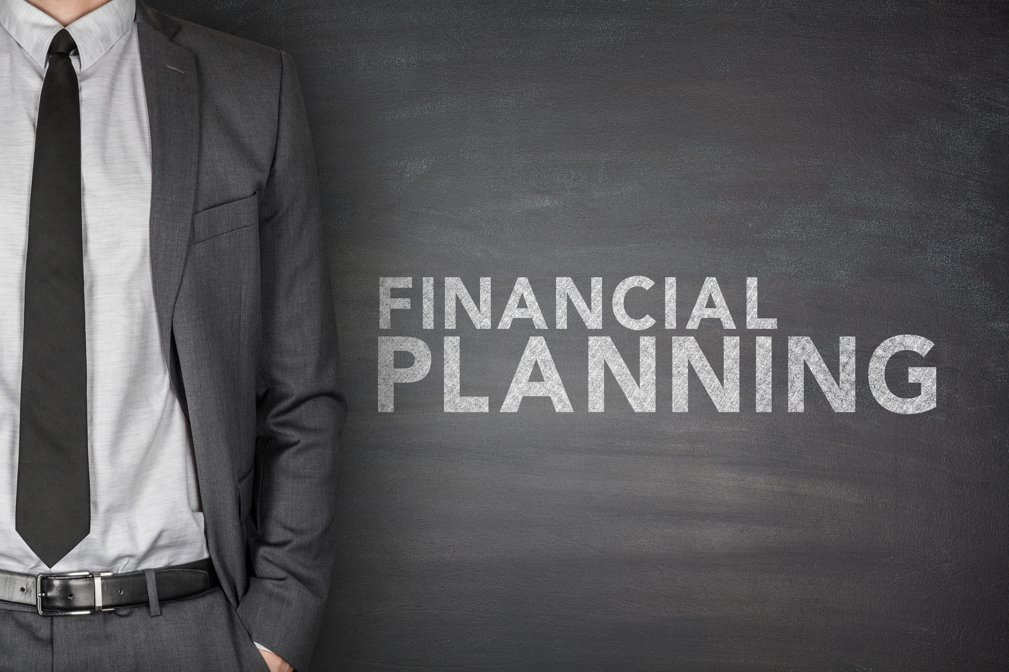 Financial planning text on black blackboard with businessman