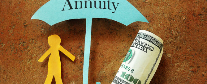 Annuity umbrella over a paper cutout person and hundred dollar bill